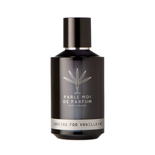 A dark brown glass perfume bottle with a black cap, featuring white text that reads 'PARLE MOI DE PARFUM PARIS-ORLES' and 'LOOKING FOR VANILLA/43'.